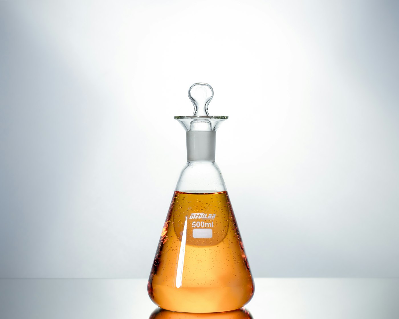 Clear glass conical flasks in a clean laboratory