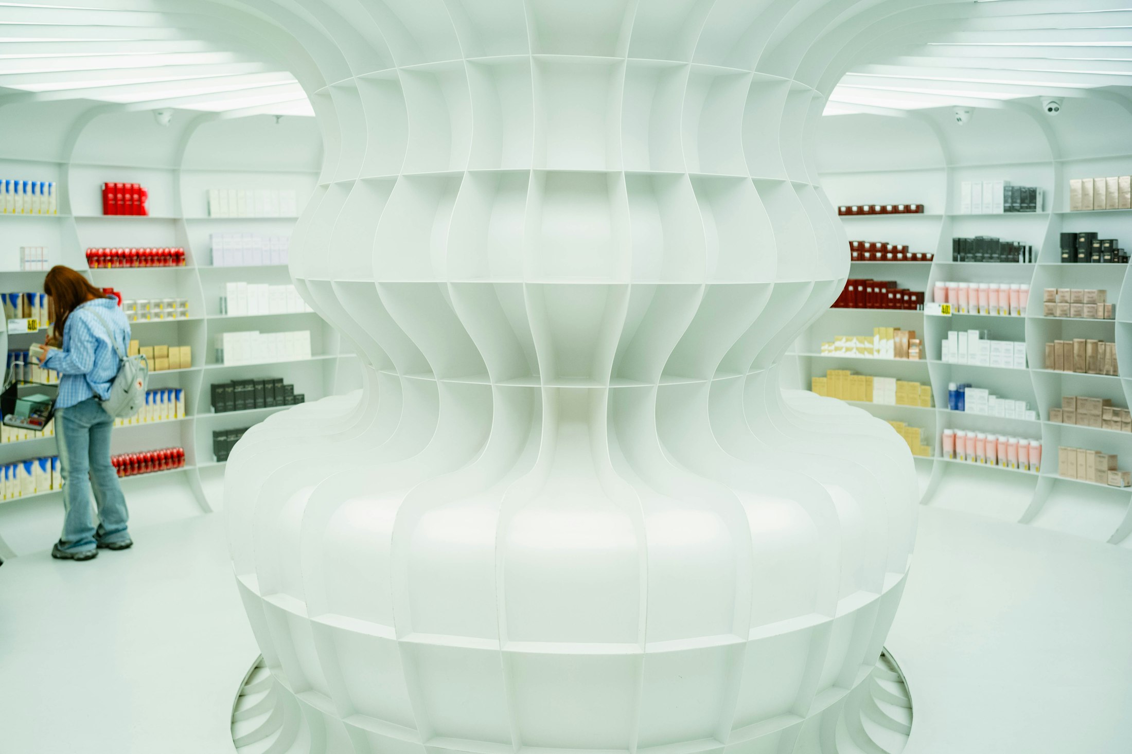 Bright white pharmacy-style shop with shelves